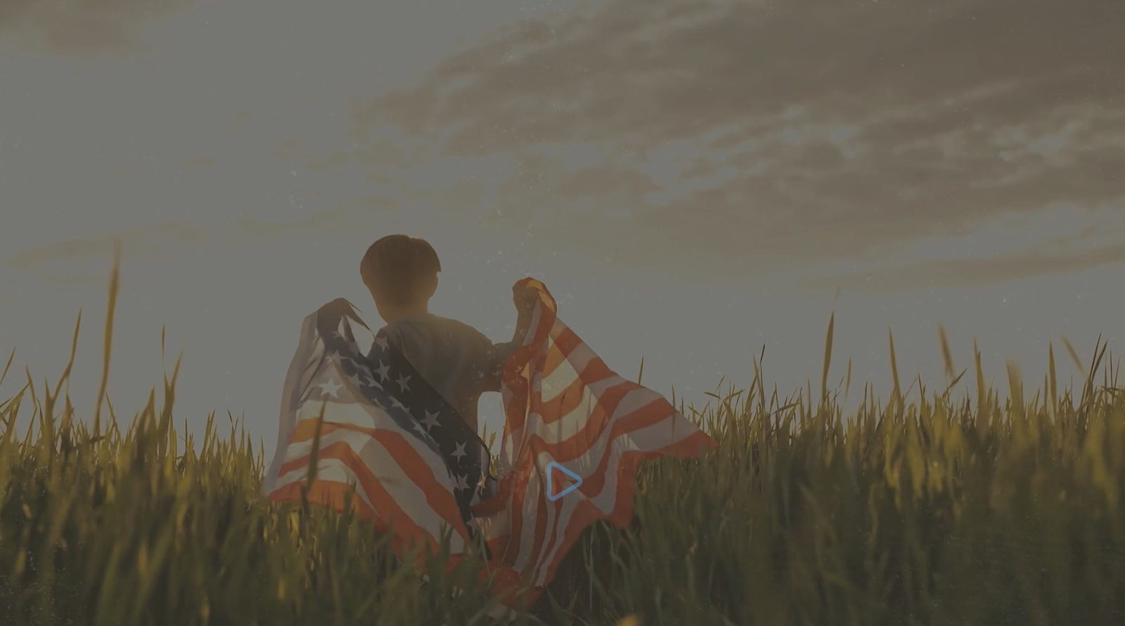 Memorial Day worship video frame of a child holding an American flag in a sunset field