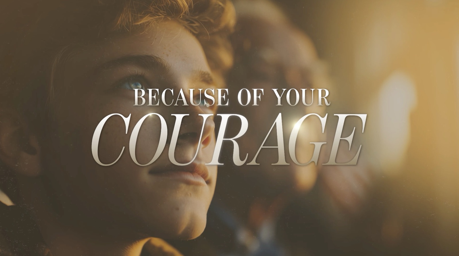 Veterans Day worship video frame showing a child looking up in golden light with overlay text Because of your courage