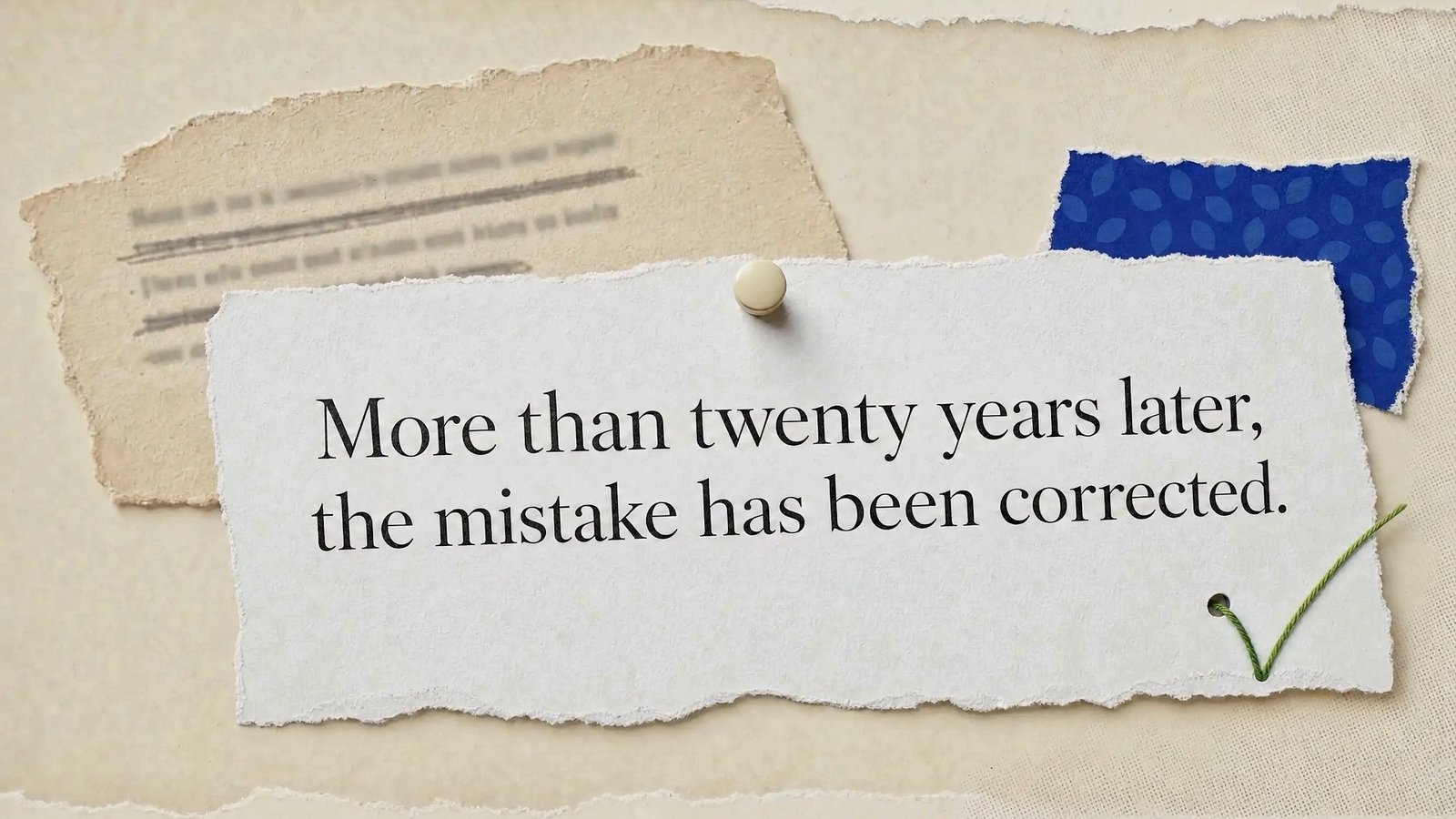 Pinned paper slip reading More than twenty years later, the mistake has been corrected, marked with a green check