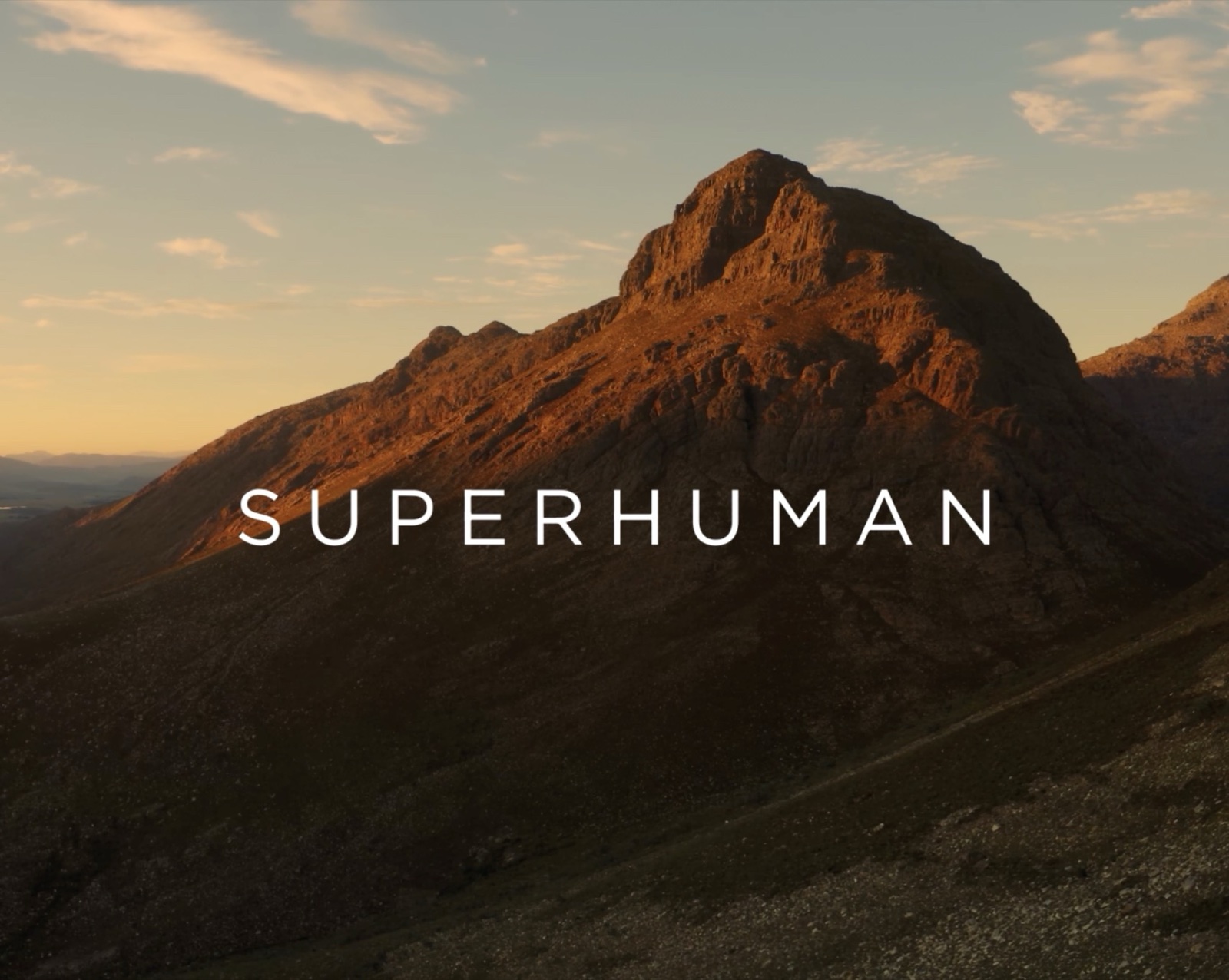 Superhuman brand title card with mountain landscape backdrop